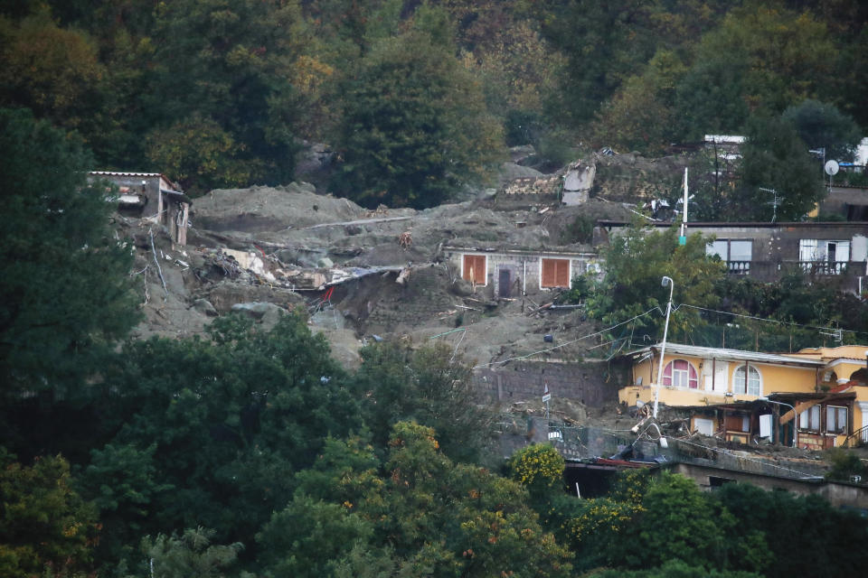 A view of flooded and mud covered houses are seen after heavy rainfall triggered landslides that collapsed buildings and left as many as 12 people missing, in Casamicciola, on the southern Italian island of Ischia, Saturday, Nov. 26, 2022. Firefighters are working on rescue efforts as reinforcements are being sent from nearby Naples, but are encountering difficulties in reaching the island either by motorboat or helicopter due to the weather. (AP Photo/Salvatore Laporta)