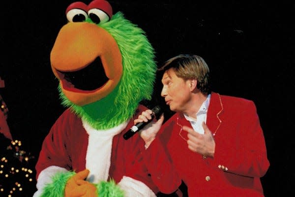 Mark Milovats, with an assist from the Pirate Parrot, entertains at one of the pop singer's annual Christmas concerts.