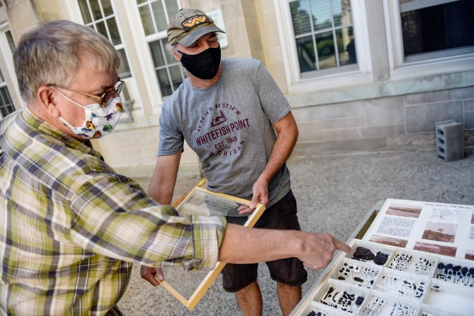 Gary Parsons, director of the MSU Bug House (left), talks about a collection with MSU Professor Anthony Cognator outside the College of Natural Science at Michigan State.