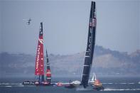 Oracle Team USA (R) sails towards the finish line ahead of Emirates Team New Zealand during Race 12 of the 34th America's Cup yacht sailing race in San Francisco, California September 19, 2013. Oracle Team USA won race 12. REUTERS/Stephen Lam (UNITED STATES - Tags: SPORT YACHTING)