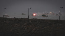 Fishing vessels at sea off the coast of Jersey, Thursday, May 6, 2021. French fishermen angry over loss of access to waters off their coast have gathered their boats in protest off the English Channel island of Jersey. The head of a grouping of Normandy fishermen said about 50 boats from French ports joined the protest Thursday morning and gathered their fleet off the Jersey port of St. Helier. (Oliver Pinel via AP)