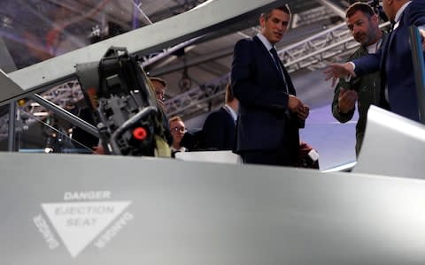 Britain's defence minister, Gavin Wiliamson, looks at the cockpit of a model of a new jet fighter, called 'Tempest' at the Farnborough Airshow