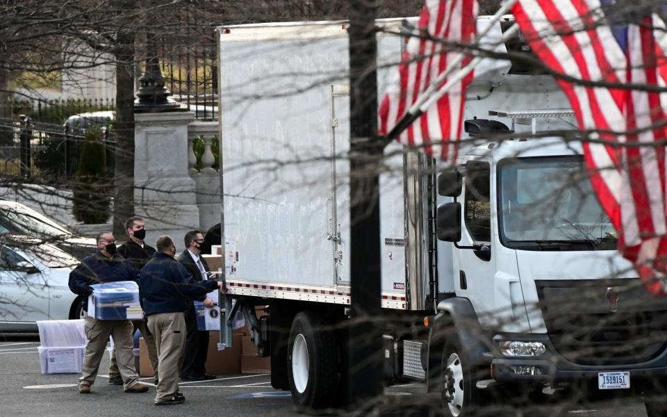 Workers move boxes from the Eisenhower Executive Office Building into a truck on the White House grounds, before the departure of President Donald Trump - Erin Scott /REUTERS