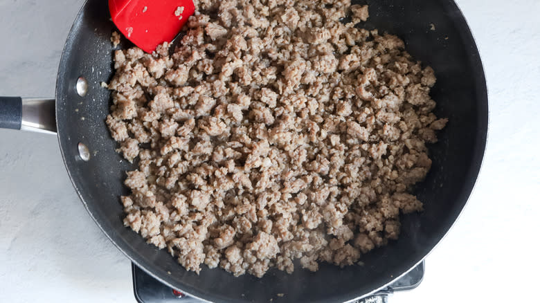 cooking sausage in skillet