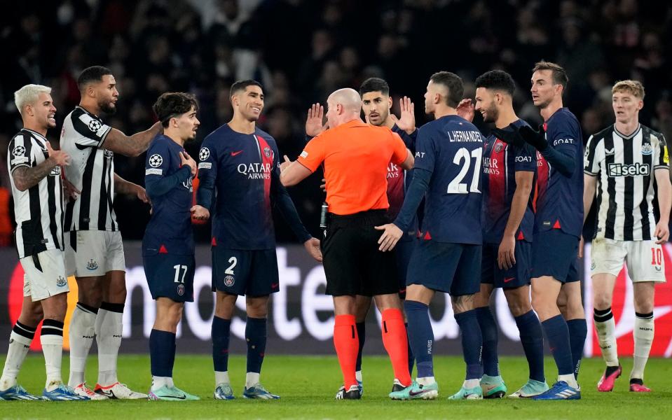 PSG players surround the referee during their draw with Newcastle