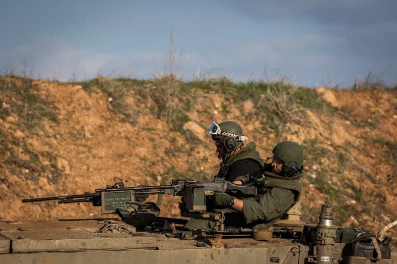 An Israeli tank driving along the border of Israel and Gaza as fighting between Israeli troops and Islamist Hamas militants continues. Ilia Yefimovich/dpa