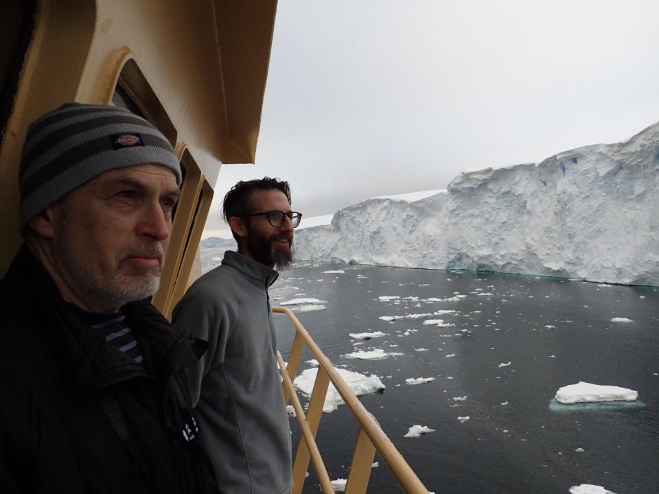 Thwaites Offshore Research (THOR) scientists Alastair Graham (right) and Robert Larter (left) look on in awe at the crumbling ice face of the Thwaites Glacier margin, from the bridge deck of the R/V Nathaniel B. Palmer.  / Credit: Frank Nitsche/University of South Florida