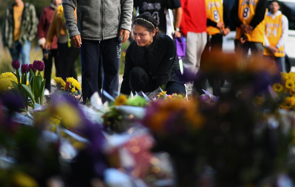Sophy Peniche of Camarillo pays her respects at a makeshift memorial outside of Kobe Bryant's Mamba Sports Academy.