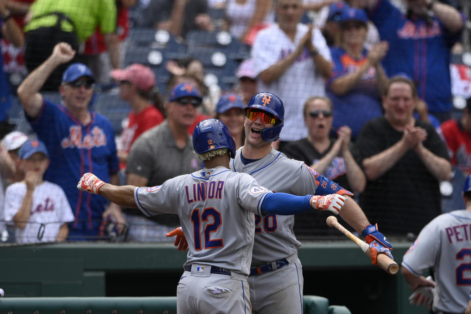 New York Mets' Francisco Lindor (12) celebrates his two-run home run with Pete Alonso (20) during the fifth inning of the first baseball game of a doubleheader against the Washington Nationals, Saturday, June 19, 2021, in Washington. This is a makeup of a postponed game from April 1. (AP Photo/Nick Wass)