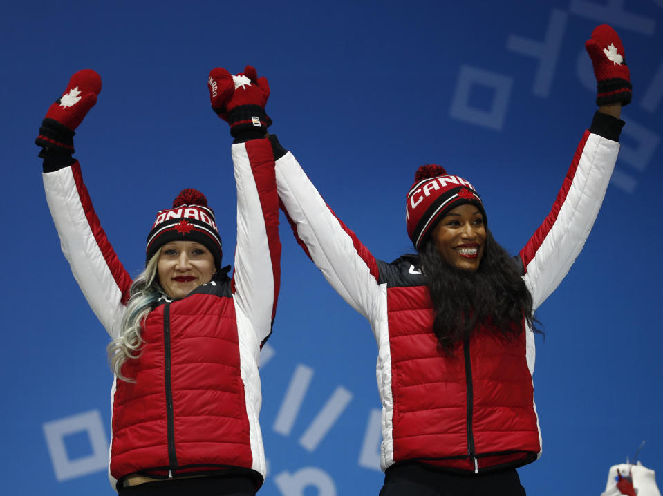Bronze medalist in the women’s two-man bobsled Kaillie Humphries and Phylicia George, of Canada, celebrate during the medals ceremony at the 2018 Winter Olympics in Pyeongchang, South Korea, Thursday, Feb. 22, 2018. (AP Photo/Patrick Semansky)