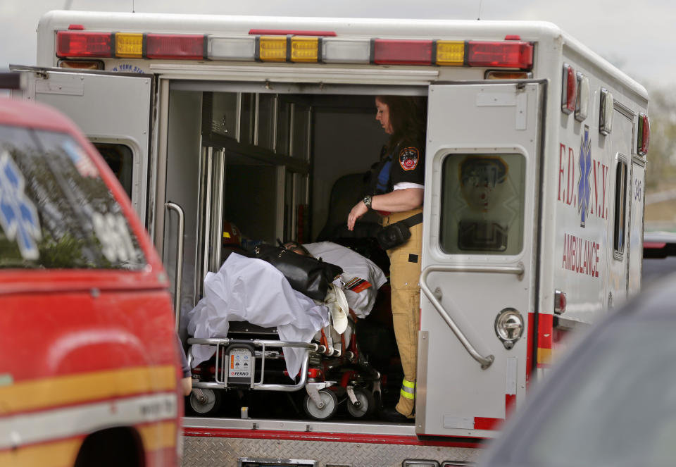 A New York City fire department EMT prepares to transport a woman who was evacuated from a subway train after it derailed in the Queens borough of New York, Friday, May 2, 2014. (AP Photo/Julie Jacobson)