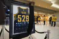 A jersey honoring Bobby "Slick" Leonard is displayed in the lobby before an NBA basketball game between the Indiana Pacers and the Los Angeles Clippers, Tuesday, April 13, 2021, in Indianapolis. The Indiana Pacers announced that the man who led them to three ABA championships during a Hall of Fame coaching career and was selected a 1963 NBA All-Star had died. (AP Photo/Darron Cummings)