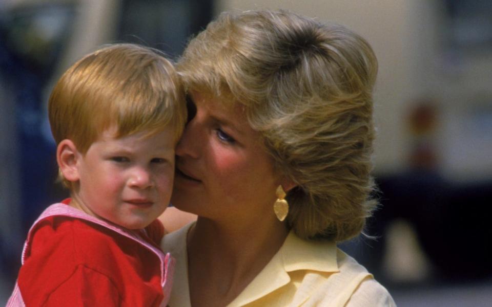 Prince Harry is pictured with his mother, Diana, Princess of Wales on holiday in Majorca in 1987 - Princess Diana Archive