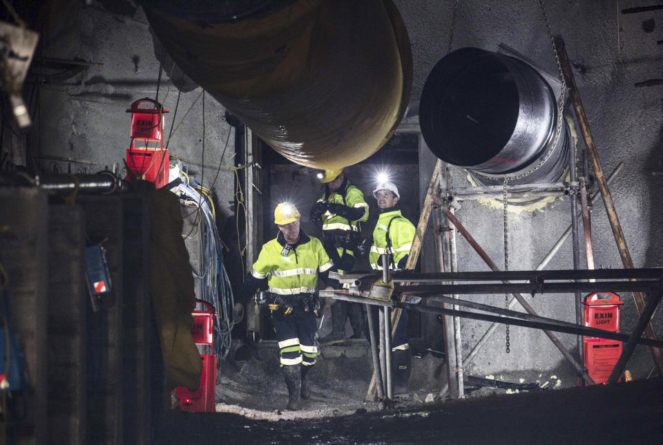 In this image released by the Pike River Recovery Agency, workers react after the first of the two airlock doors was opened in the Pike River Mine, near Greymouth on the West Coast of New Zealand, Tuesday, May 21, 2019. Crews in New Zealand on Tuesday reentered an underground coal mine where a methane explosion killed 29 workers more than eight years ago, raising hopes among family members that they might find bodies and new evidence that leads to criminal charges. (Neil Silverwood/Pike River Recovery Agency via AP)