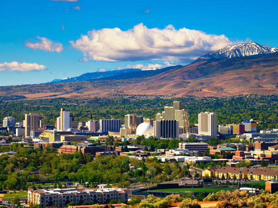 Downtown Reno skyline, Nevada, with hotels, casinos, and the surrounding High Eastern Sierra foothills