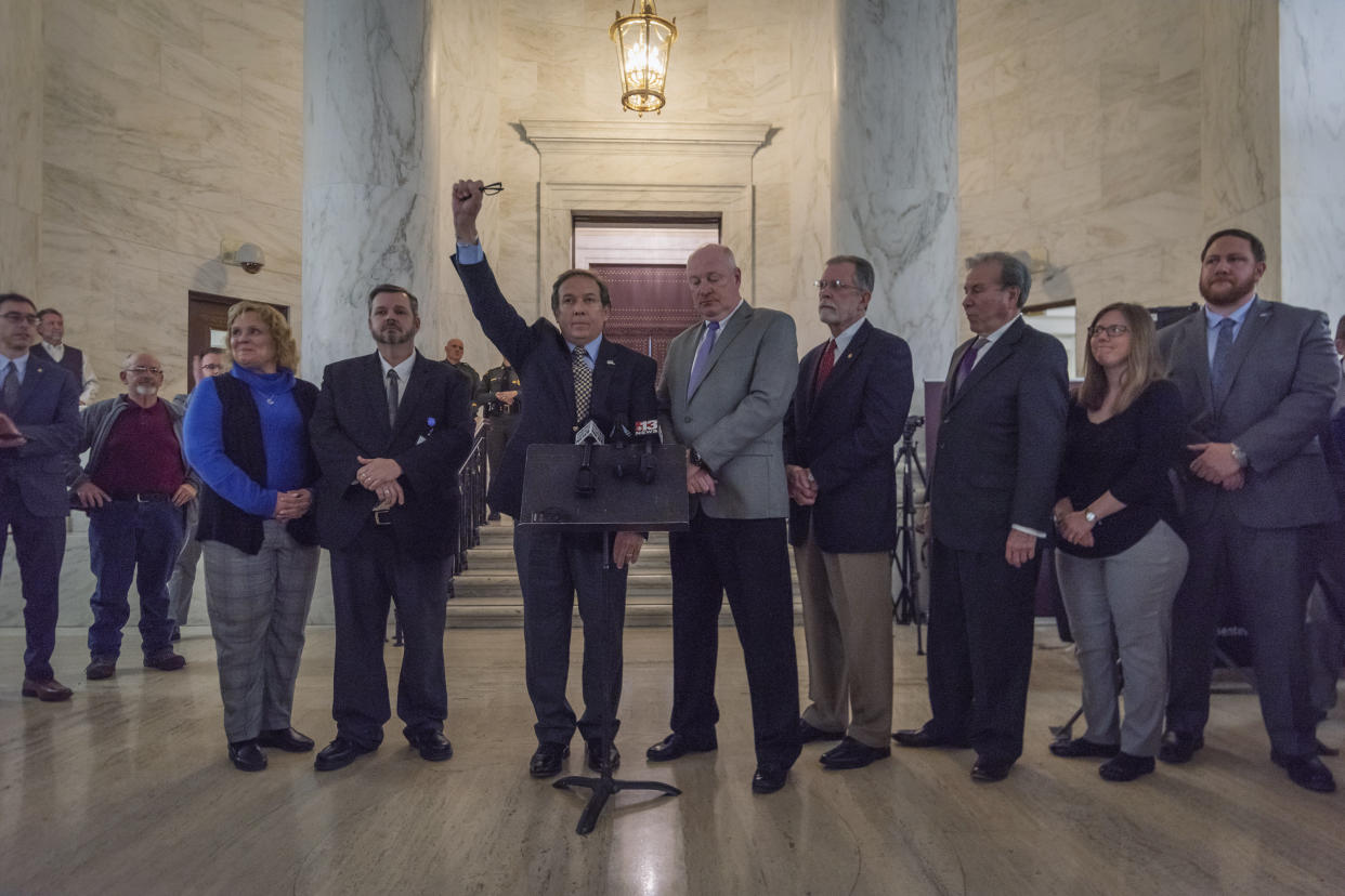 With his fist raised, Fred Albert, president of the American Federation of Teachers-West Virginia, joins other union leaders in a call for a statewide strike beginning Tuesday. (Photo: Craig Hudson/Charleston Gazette-Mail via ASSOCIATED PRESS)