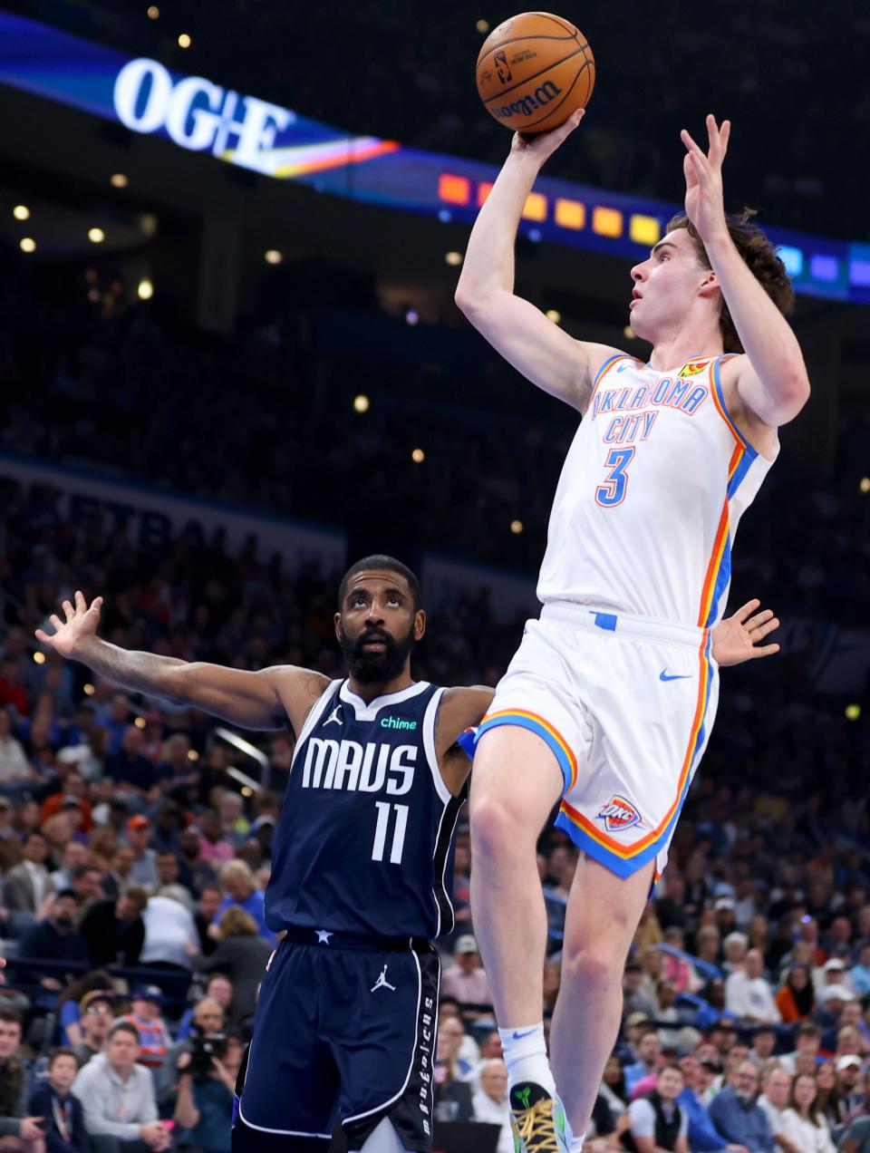 Oklahoma City Thunder's Josh Giddey (3) goes up for a basket as Dallas Mavericks' Kyrie Irving (11) defends in the first half of the NBA basketball game between the Oklahoma City Thunder and Dallas Mavericks at Paycom Center in Oklahoma City, Thursday, March 14, 2024.