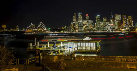 A ferry draws streaks of light in this time exposure as it arrives then departs Sydney's Jeffrey Street wharf late July 13, 2015. REUTERS/Jason Reed