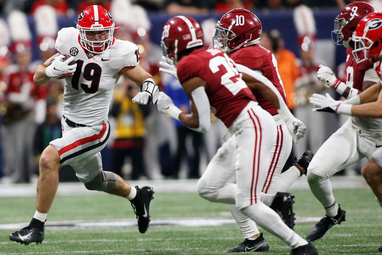 Georgia tight end Brock Bowers (19) moves the ball down the field during the first half of the Southeastern Conference championship NCAA college football game between Georgia and Alabama in Atlanta, on Saturday, Dec. 4, 2021. 