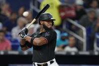 Miami Marlins' Bryan De La Cruz leans back to avoid a close pitch during the fourth inning of a baseball game against the Atlanta Braves, Tuesday, Oct. 4, 2022, in Miami. (AP Photo/Wilfredo Lee)