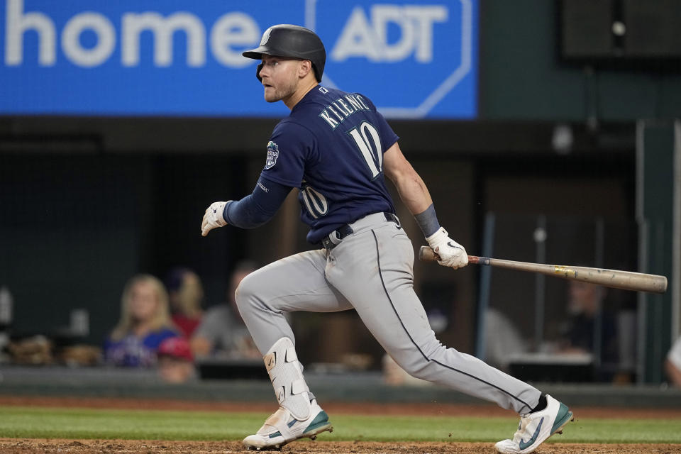 Seattle Mariners' Jarred Kelenic follows through on a run-scoring single in the seventh inning of a baseball game against the Texas Rangers, Sunday, Sept. 24, 2023, in Arlington, Texas. Cal Raleigh scored on the hit. (AP Photo/Tony Gutierrez)