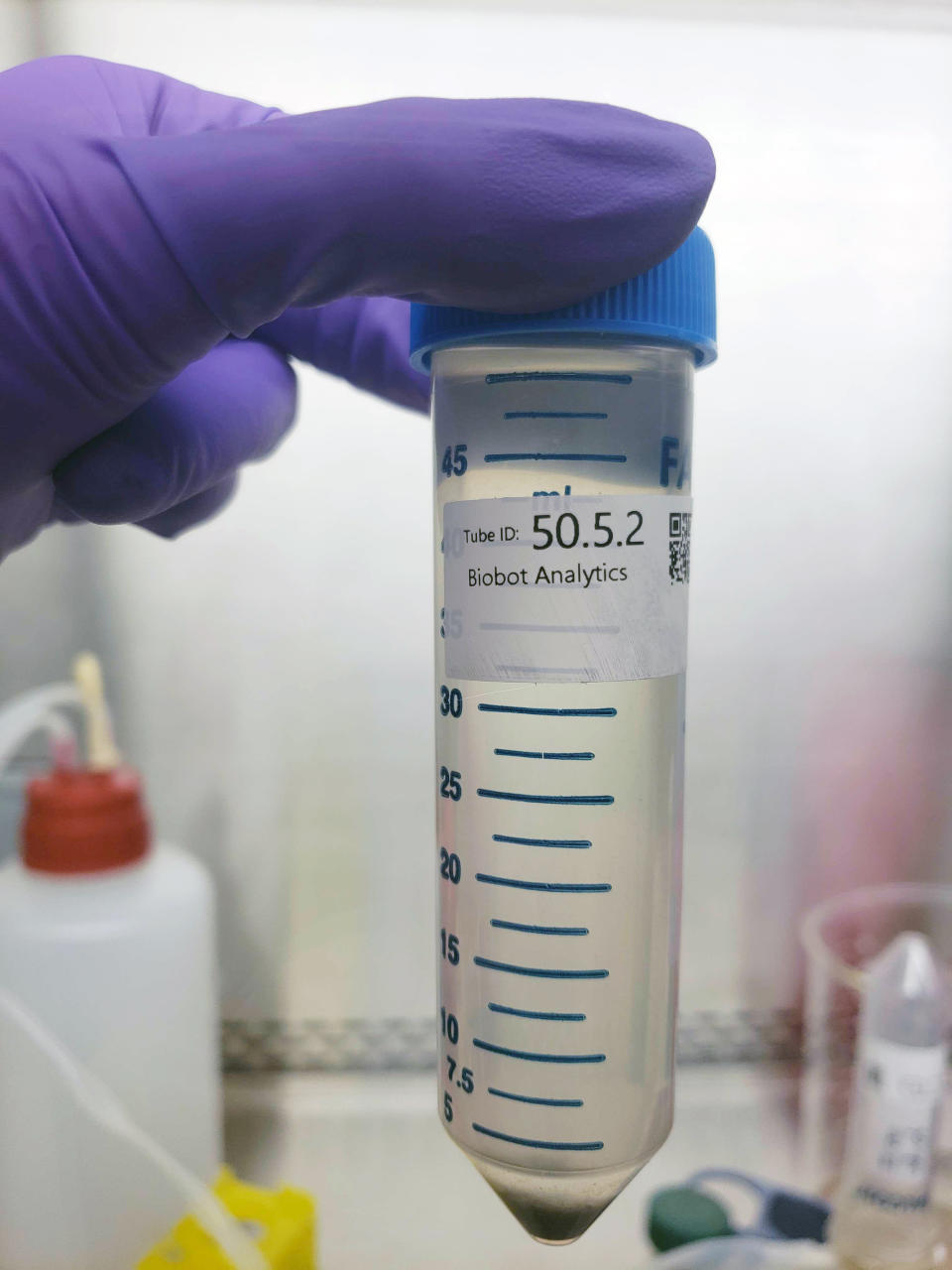 In this undated photo provided by Biobot in June 2020, a technician holds a wastewater sampling tube. Across the U.S. and in Europe, researchers and health officials say they can track the course of a community outbreak by studying the waste flushed from its bathrooms. And that can provide a valuable addition to public health tools, they say. (Biobot via AP)