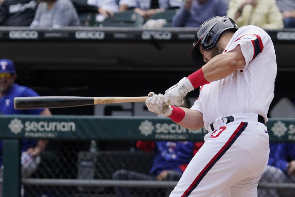 Chicago White Sox's Jake Burger hits a one-run single against the Texas Rangers during the first inning of a baseball game in Chicago, Sunday, June 12, 2022. (AP Photo/Nam Y. Huh)