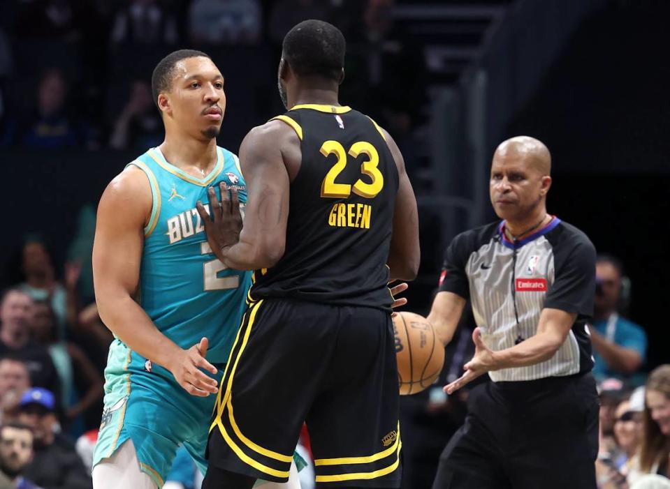 Charlotte Hornets forward Grant Williams, left, stands in place as Golden State Warriors forward Draymond Green, right, puts a hand into Williams’ chest during second-half action at Spectrum Center in Charlotte, NC on Friday, March 29, 2024. The Warriors defeated the Hornets 115-97.