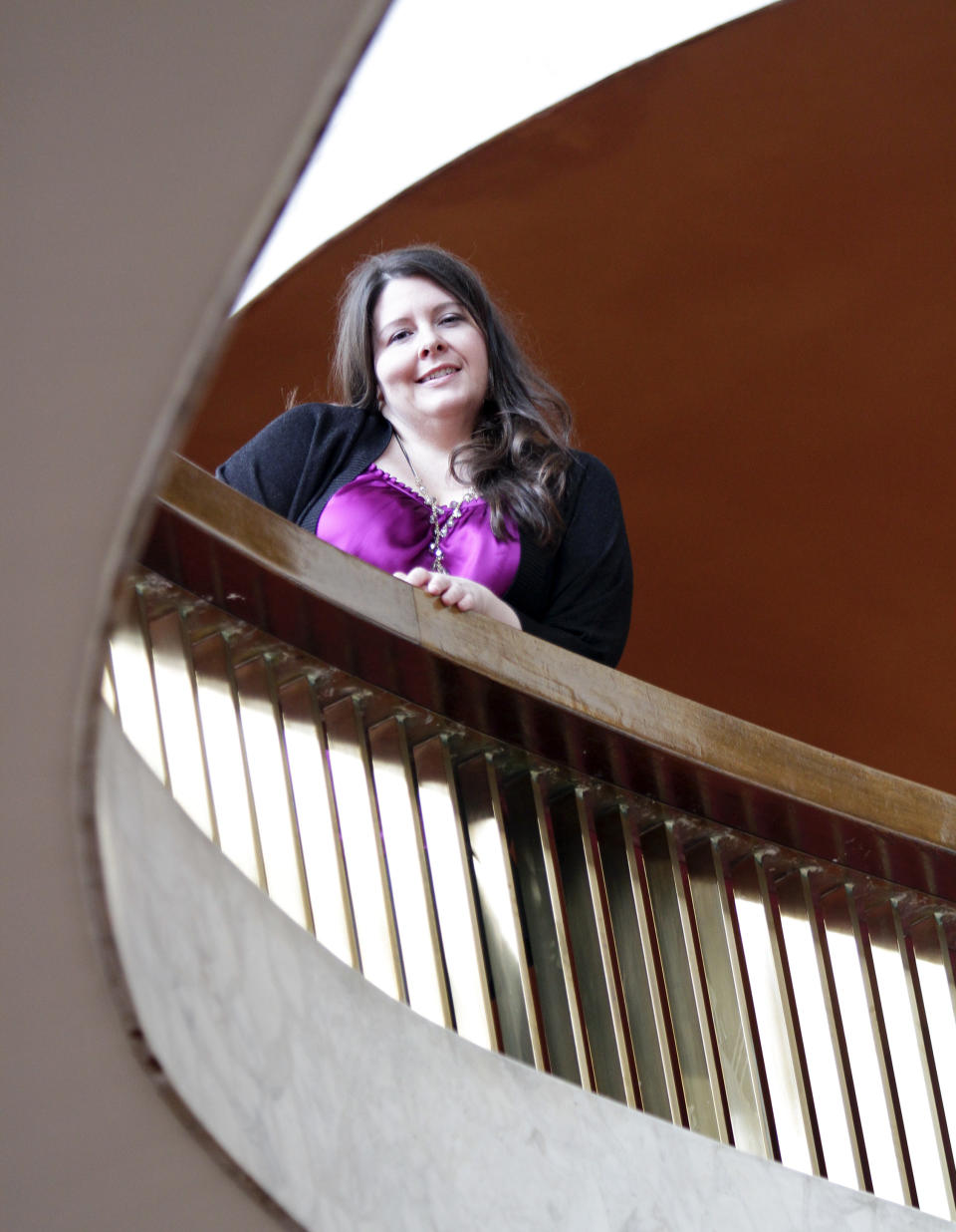 Soprano Angela Meade, recipient of the 2012 Beverly Sills Artist Award, pose inside the Metropolitan Opera lobby at Lincoln Center on Wednesday, Feb. 15, 2012 in New York. Meade will reach an international audience in a single performance as she plays the lead female role, Elvira, in the Metropolitan Opera's high-definition global broadcast performance of Giuseppi Verdi's early opera "Ernani," on Saturday, Feb. 25. (AP Photo/Bebeto Matthews)