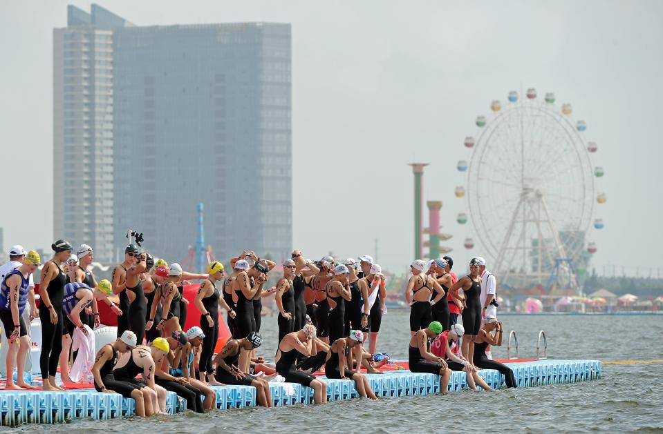 Competitors get ready before the women's 10km open water swimming event of the FINA World Championships in Shanghai on July 19, 2011. British swimmer Keri-Anne Payne, who took silver at the 2008 Beijing Games, swam the women's 10km open water in 2hr 1min 58.1secs, winning ahead of Italy's Martina Grimaldi and Marianna Lymperta of Greece and ramping up hopes for London 2012.  AFP PHOTO/PHILIPPE LOPEZ (Photo credit should read PHILIPPE LOPEZ/AFP/Getty Images)