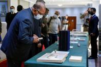 Officials look at artifacts seized by the U.S. government and returned to Iraq, which are on display at the Ministry of Foreign Affairs in Baghdad