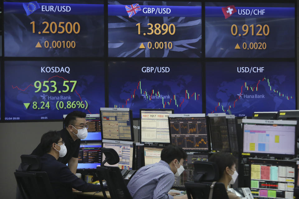 Currency traders watch monitors at the foreign exchange dealing room of the KEB Hana Bank headquarters in Seoul, South Korea, Tuesday, May 4, 2021. Asian shares were mixed Tuesday after strong corporate earnings and economic data lifted stocks on Wall Street. (AP Photo/Ahn Young-joon)