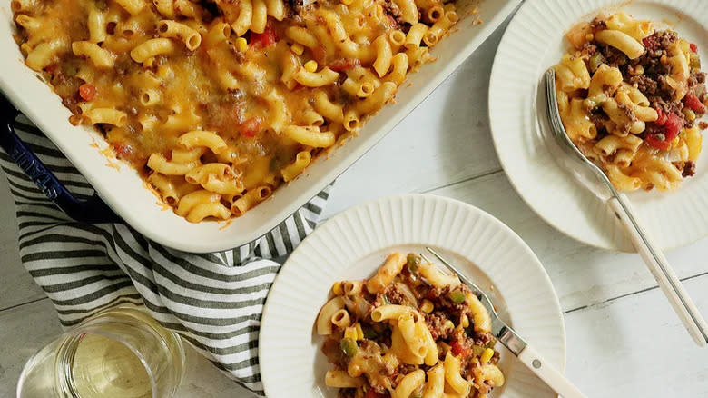 Top-down view of dish and plates of hamburger casserole