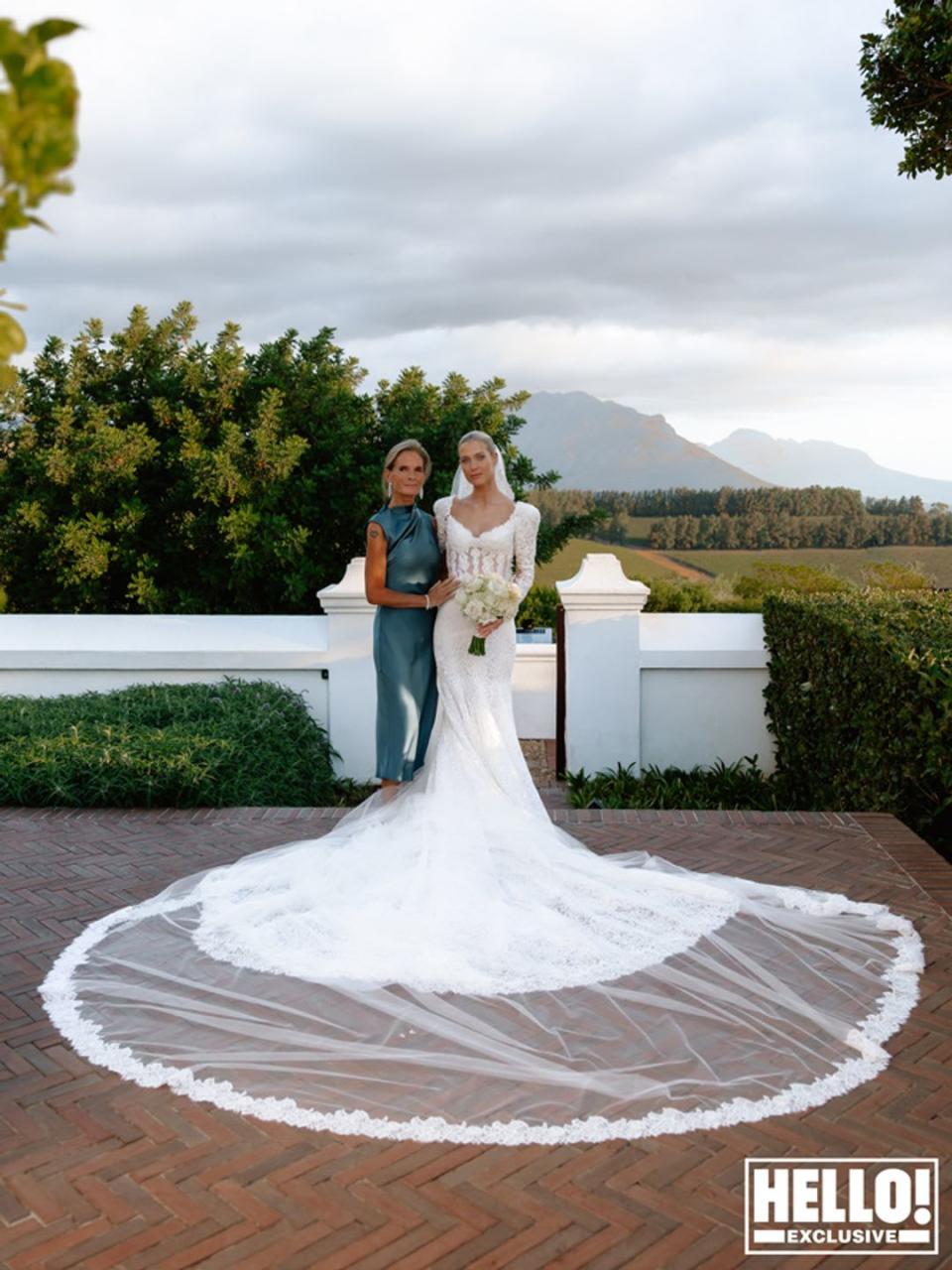 Lady Amelia Spencer posing for wedding photos with her mother Victoria with mountains behind them