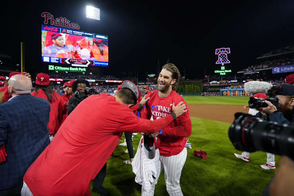 Philadelphia Phillies' Bryce Harper, right, and Trea Turner celebrate after winning a baseball game against the Pittsburgh Pirates to clinch a wild-card playoff spot, Tuesday, Sept. 26, 2023, in Philadelphia. (AP Photo/Matt Slocum)