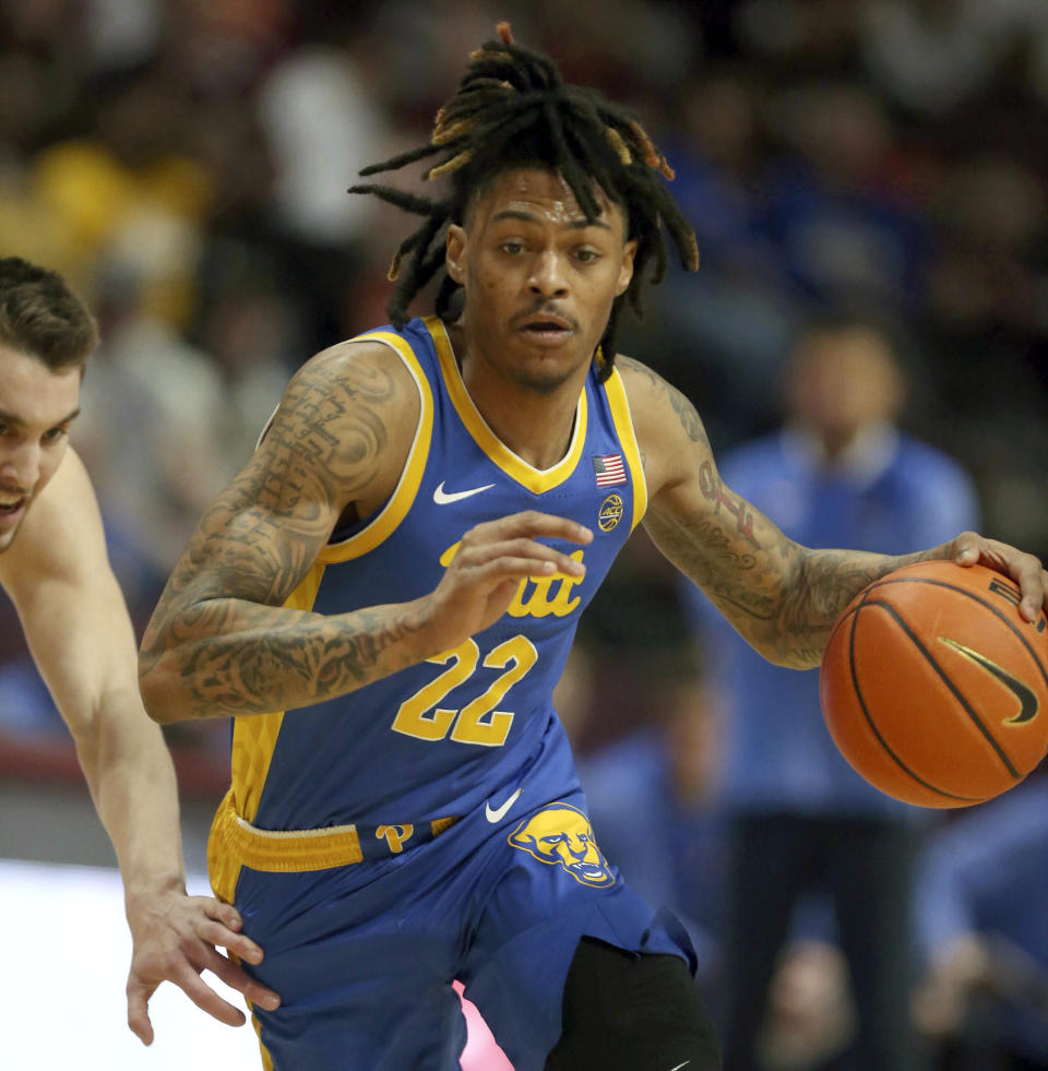 RETRANSMISSION TO CORRECT ID TO JOHN CAMDEN - Pittsburgh's Nike Sibande (22) dives to the basket past Virginia Tech's John Camden, left, during the first half of an NCAA college basketball game in Blacksburg, Va., Saturday, Feb. 18, 2023. (Matt Gentry/The Roanoke Times via AP)