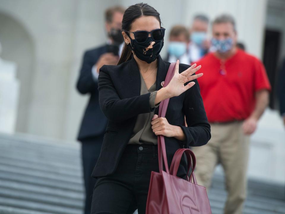 AOC wore Telfar Shopping Bag in the color "Oxblood."