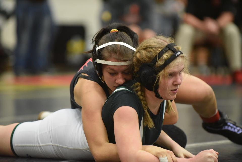 Clinton's Faith Blackburn (top) wrestles Destyni Monroe oF Sand Creek in the 135 pound girls match at the Lenawee County All-Star Wrestling Tournament on Friday at Adrian College.