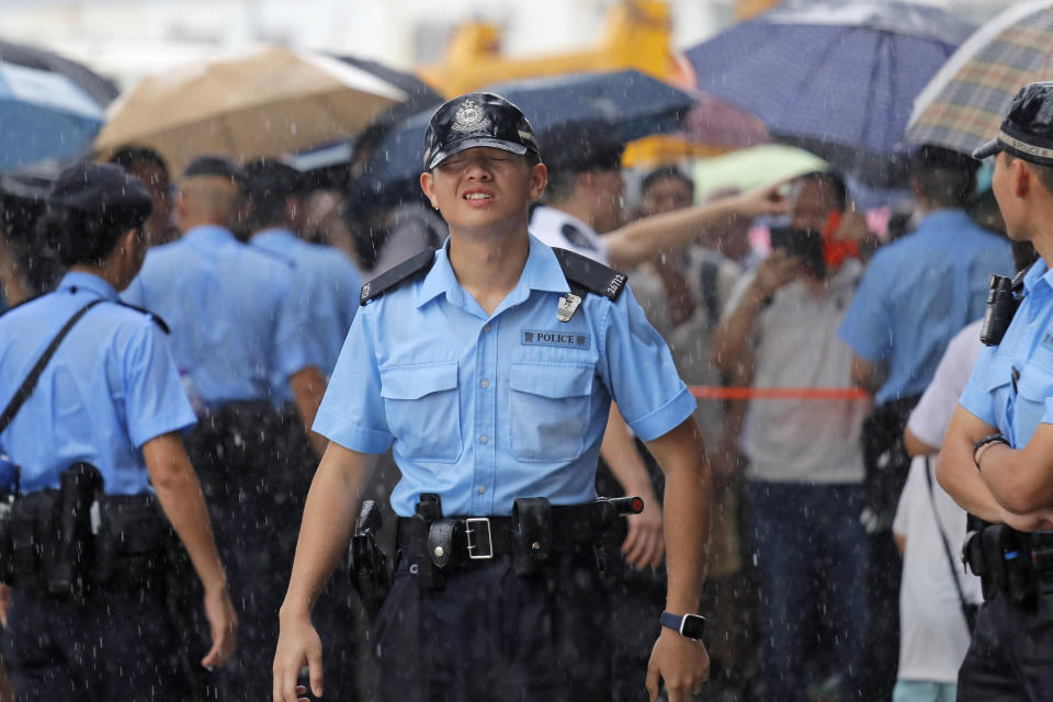 Police officers stand guard during a rally outside Legislative Council Complex in Hong Kong, Sunday, June 30, 2019. Pro-China's supporters rallied in support of the police at Tamar Park (AP Photo/Kin Cheung)