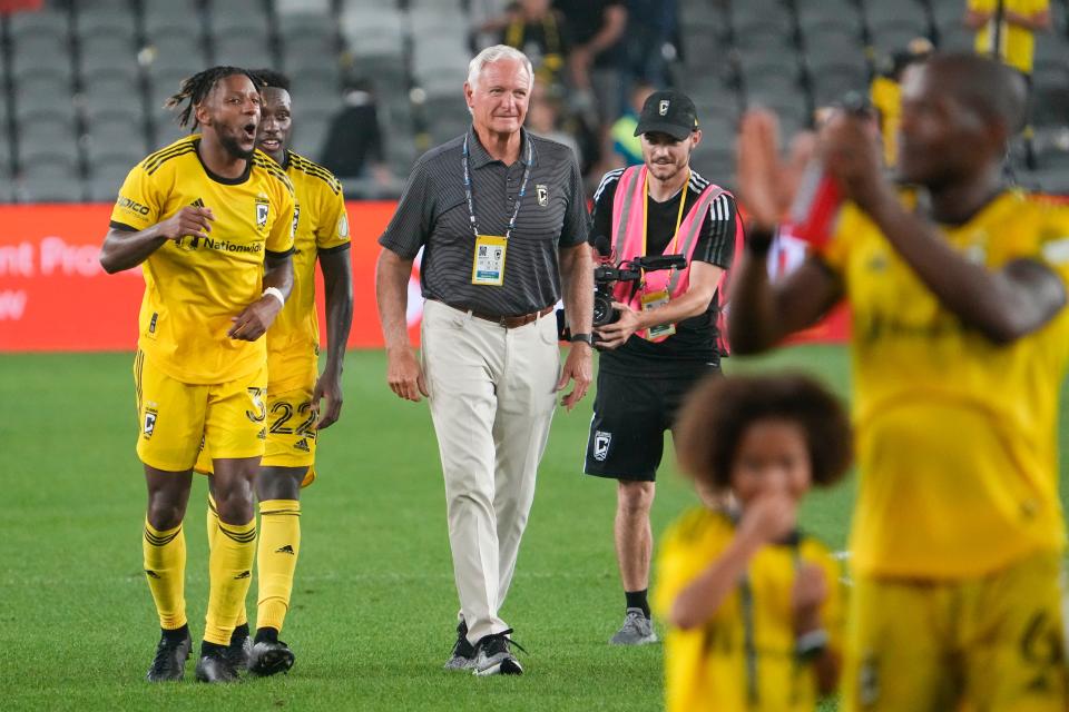 Crew co-owner Jim Haslam celebrates on the field with players following their 2-0 win over FC Cincinnati, July 17, 2022, in Columbus.