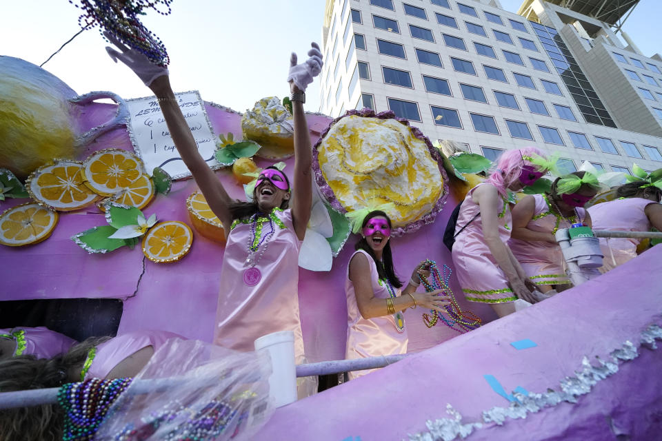 Riders toss throws from a float during a parade dubbed "Tardy Gras," to compensate for a cancelled Mardi Gras due to the COVID-19 pandemic, in Mobile, Ala., Friday, May 21, 2021. (AP Photo/Gerald Herbert)