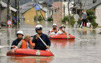 <p>Residents are rescued by boat in Kurashiki, Okayama prefecture, western Japan Saturday, July 7, 2018. (Photo: Kyodo News via AP) </p>