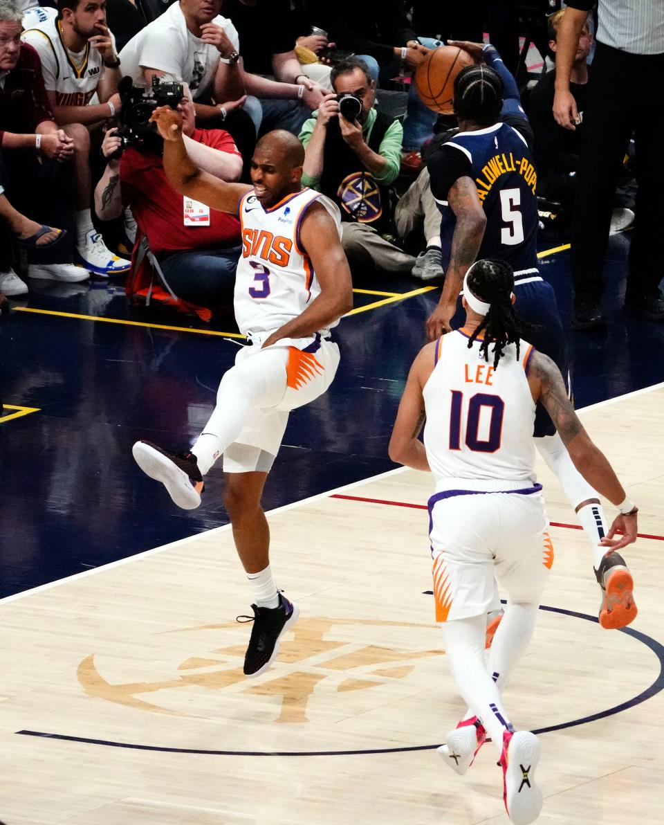 Phoenix Suns guard Chris Paul (3) reaches for his groin while defending Denver Nuggets guard Kentavious Caldwell-Pope (5) in the third quarter during Game 2 of the Western Conference Semifinals at Ball Arena in Denver on May 1, 2023.