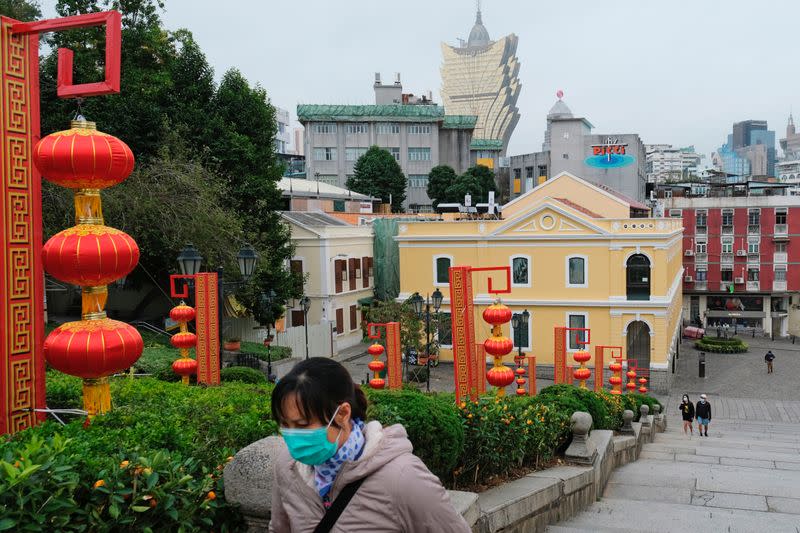 People wear masks as they walk near Ruins of St. Paul’s, following the coronavirus outbreak in Macau