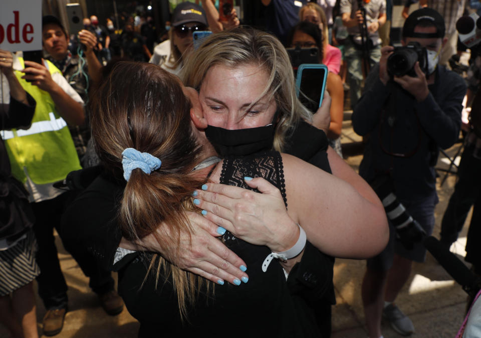 Salon owner Shelley Luther hugs a supporter after she was released from jail in Dallas, Thursday, May 7, 2020. Luther was jailed for refusing to keep her business closed amid concerns of the spread of COVID-19. (AP Photo/LM Otero)