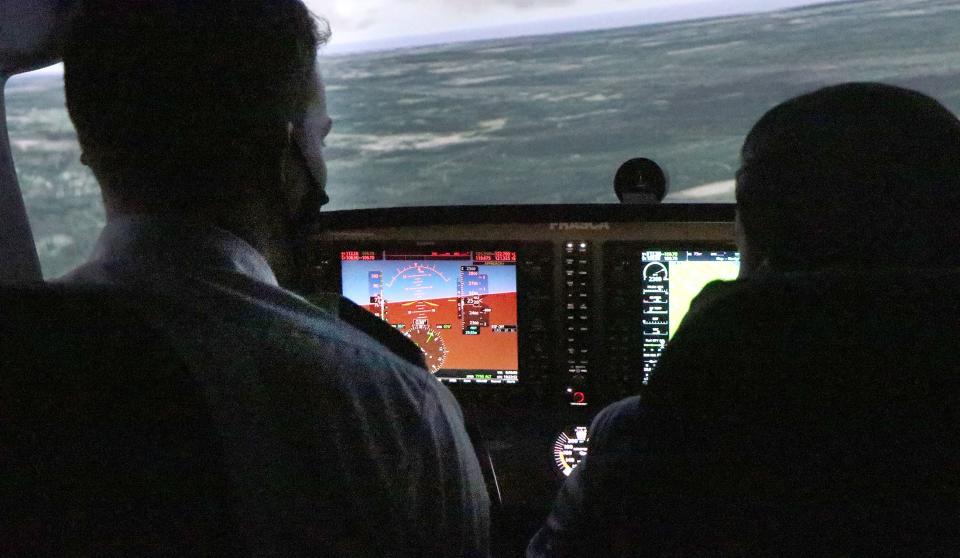 Student pilot Zack Wohlart, at left, trains in a new state-of-the-art Cessna 172 simulator with instructor Mo Alani at Epic Flight Academy at New Smyrna Beach Municipal Airport.