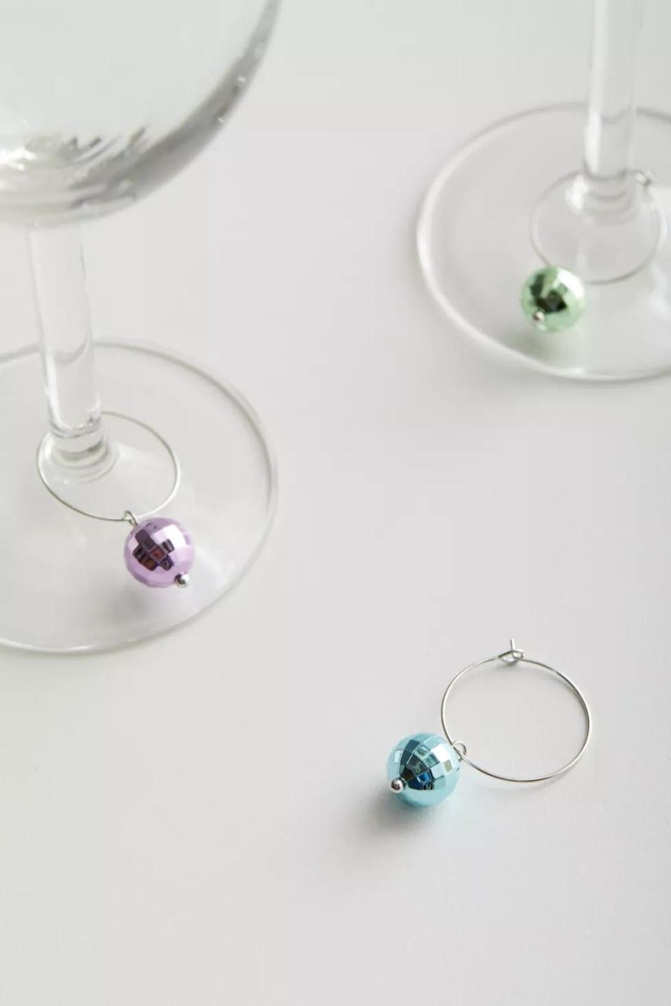 <p><a href="https://go.redirectingat.com?id=74968X1596630&url=https%3A%2F%2Fwww.urbanoutfitters.com%2Fshop%2Fdisco-ball-drink-charm-set2&sref=https%3A%2F%2Fwww.delish.com%2Fholiday-recipes%2Fg2582%2Fwine-gifts%2F" rel="nofollow noopener" target="_blank" data-ylk="slk:Shop Now;elm:context_link;itc:0;sec:content-canvas" class="link ">Shop Now</a></p><p>Disco Ball Drink Charm Set</p><p>Urban Outfitters</p><p>$14.00</p>