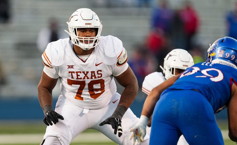 Nov 19, 2022; Lawrence, Kansas, USA; Texas Longhorns offensive lineman Kelvin Banks Jr. (78) looks to block Kansas Jayhawks defensive lineman Malcolm Lee (99) during the second half at David Booth Kansas Memorial Stadium.