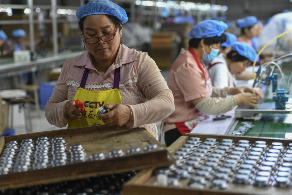 FILE - Workers assemble speakers at an electronics factory in Linquan in central China's Anhui province on May 31, 2023. China's factories picked up their pace and retail sales also gained momentum in August, the government reported Friday, Sept. 15, suggesting the economy may be gradually recovering from its post-pandemic malaise. (Chinatopix Via AP, File)