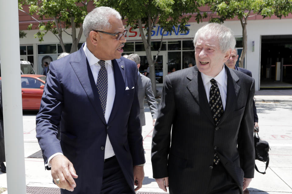 Carnival Corp. President Arnold Donald, left, arrives at federal court, Monday, June 3, 2019, in Miami. Carnival Corp. is in federal court for a hearing on what to do about allegations that it has continued polluting the oceans from some of its cruise ships despite agreeing years ago to stop (AP Photo/Lynne Sladky)